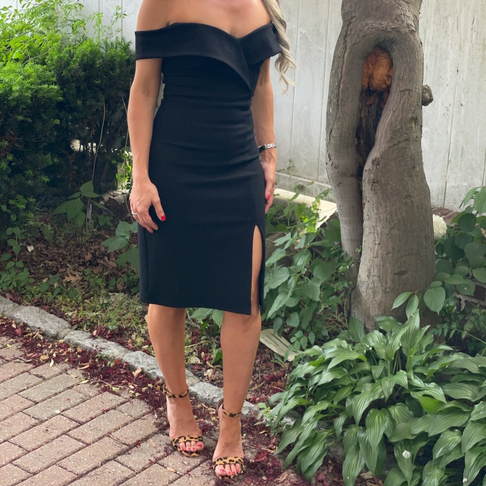 Black off the shoulder dress.